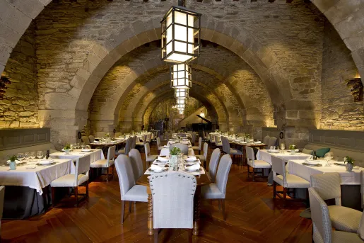 Indoor dining hall with white cushioned chairs and wooden furniture