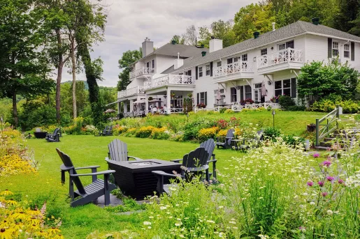 expansive lawn and fire pit outside of manor house