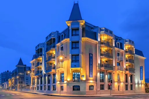 Exterior view of building illuminated by orange lights