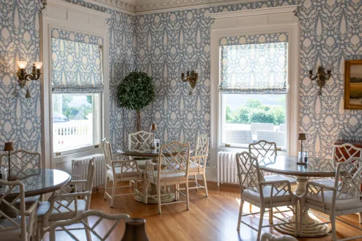 Dining hall room with circular dining tables and white chairs