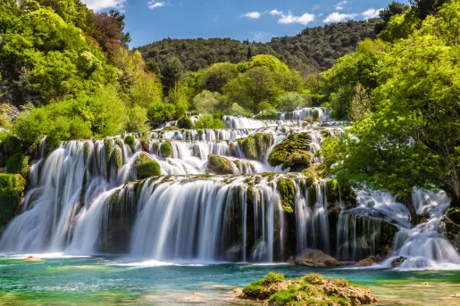 Large waterfall with a forest in the background