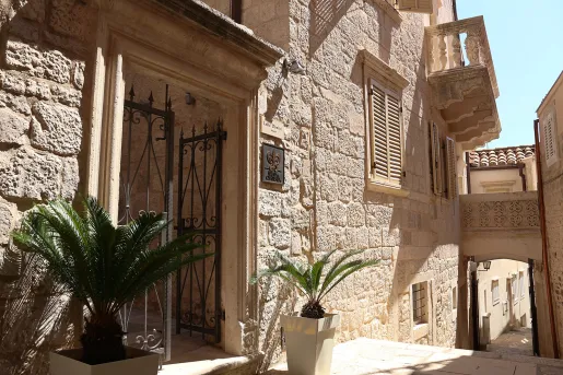 Exterior view of stone building with a narrow staircase to the right