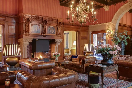 Lounge and seating area with large brown sofas and a fireplace