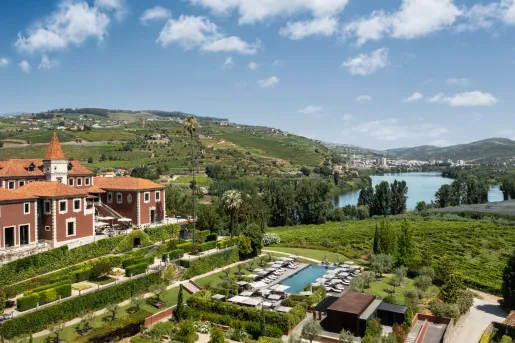 Top view of red building with a garden and outdoor pool in front