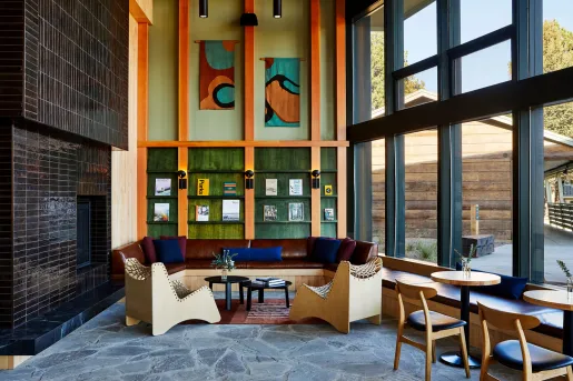 Corner room with library along the walls and large windows to the right
