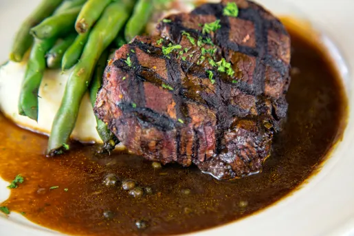 Plate with a grilled steak, peas and mashed potatoes