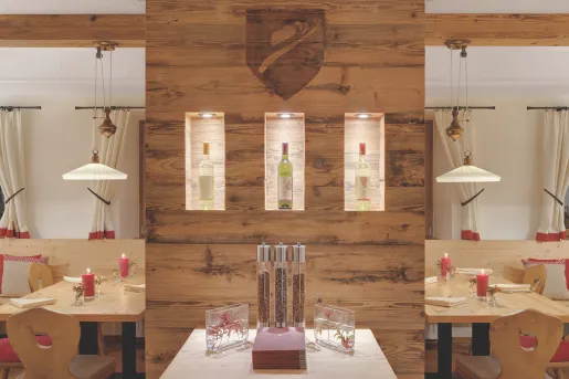Dining hall with exposed wood walls and wine bottles on shelves