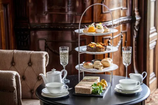 Circular table with a three-tier plate holder with pastries