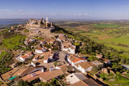 Sky view of a small hill-top town with orange and brown houses