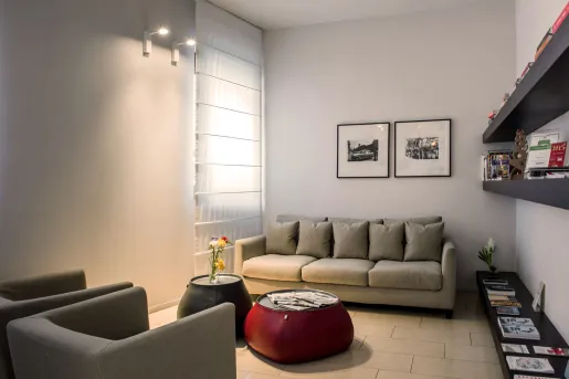 Living room seating area with gray couches and warm lights
