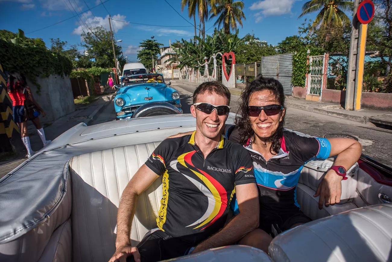 Leaders Riding in the Back of a Classic Car Cuba