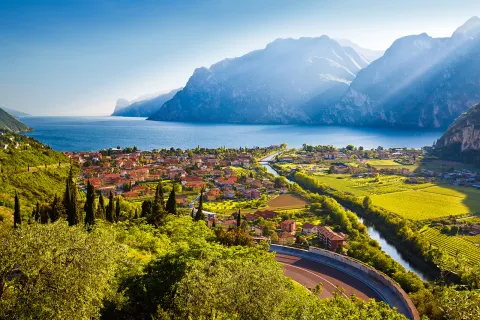 Small oceanside town with crop fields and mountains