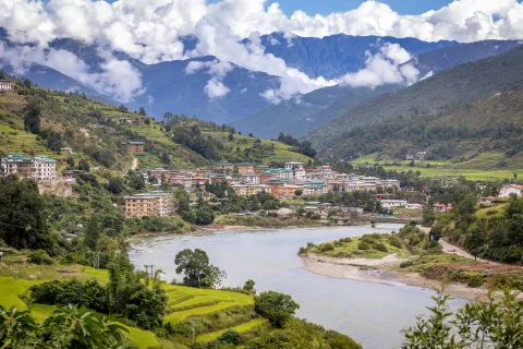 River next to  a town with tall, brown buildings