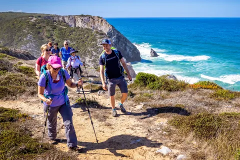 Hikers walking up a shoreline trail