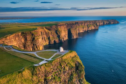 Lighthouse on top of a cliff with the ocean on the ground floor