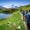 Group of guests walking past Bachalpsee Lake,