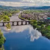 River cutting between a town with a bridge in the center