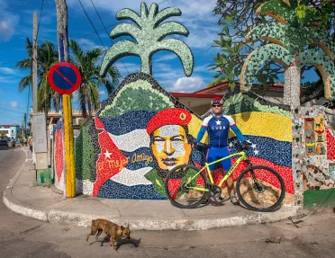 Cyclist in Front of Art Work Cuba