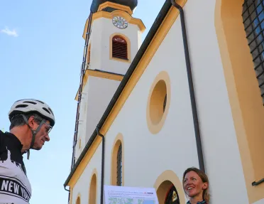 Biker showing another biker a map of the trip route.