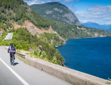 Solo biker riding along a lake in Argentina