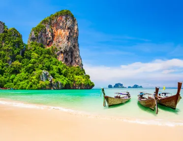 Boats resting on a sandy beach in Thailand