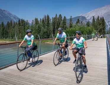 Backroads guests cycling across a bridge
