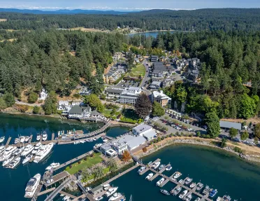 Sky view of a property complex with boats along a port 